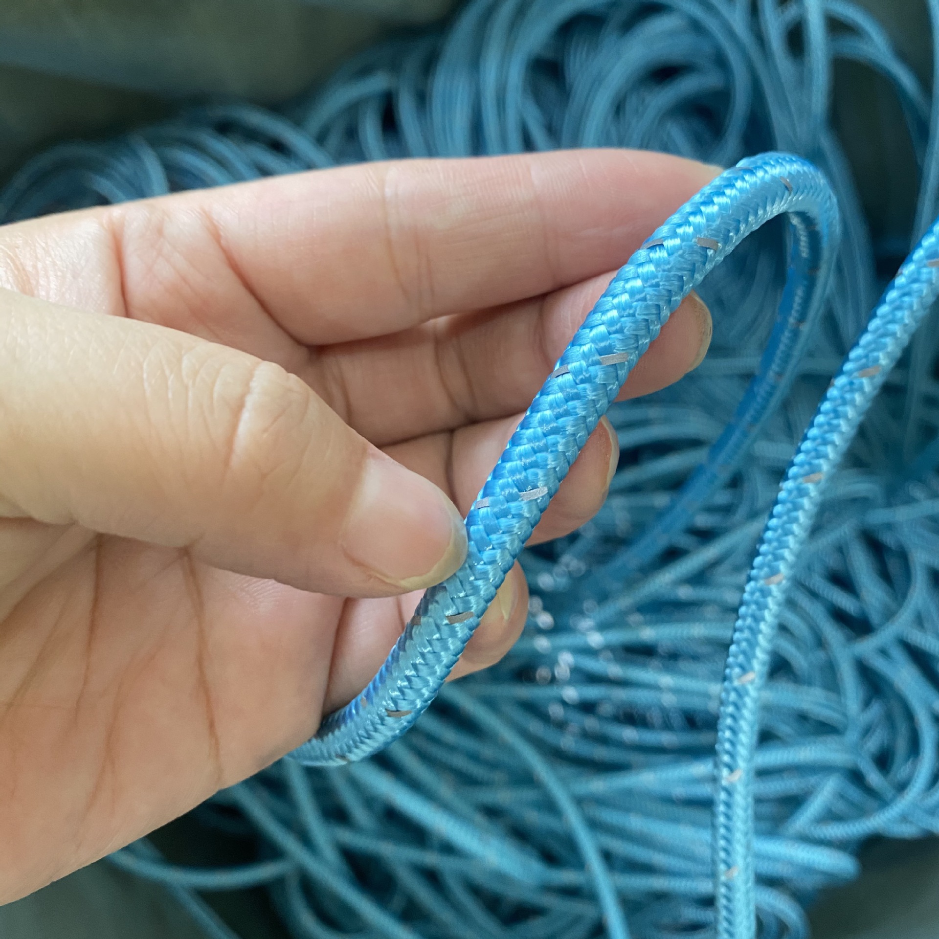 blue rope climbing equipment in left hand