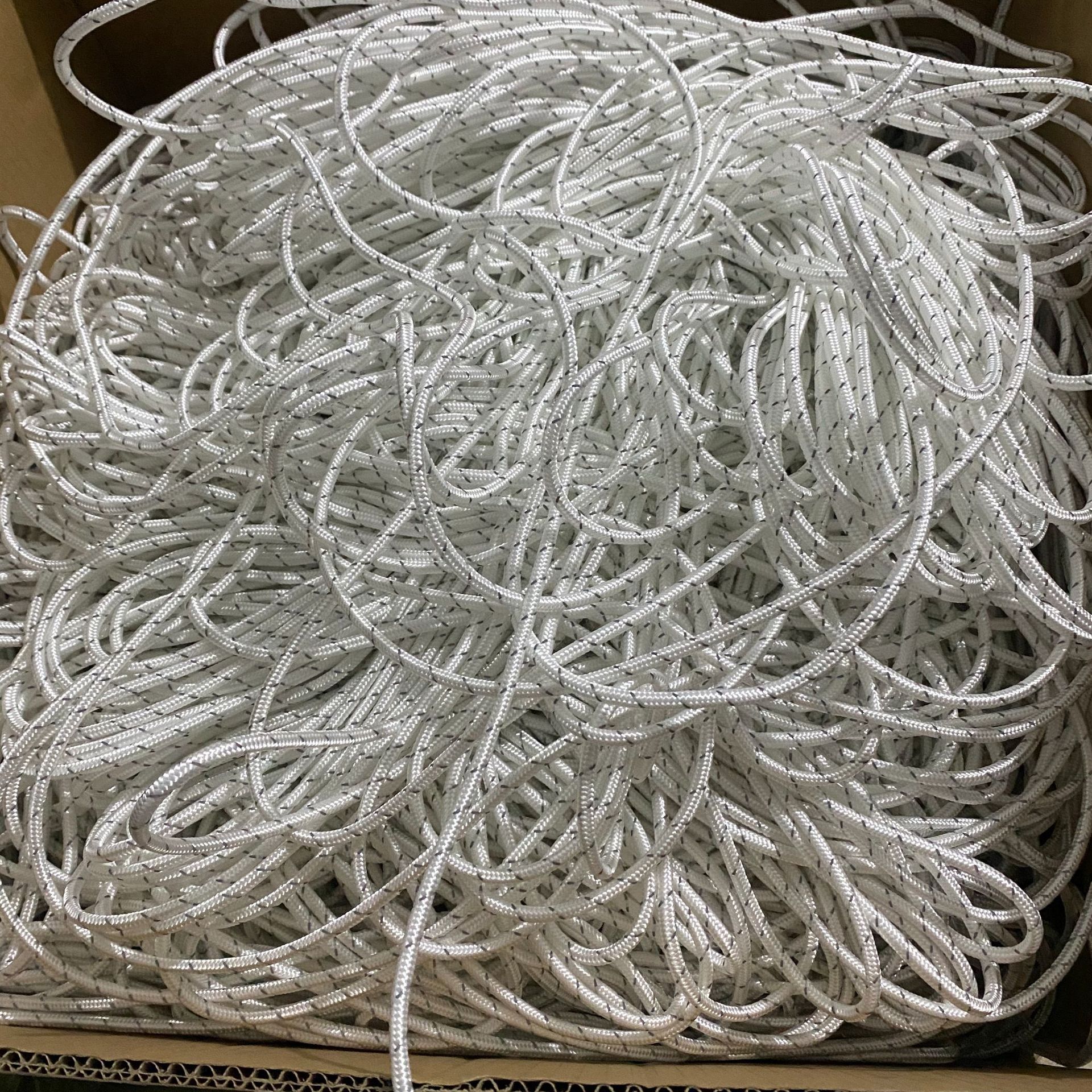 white rope climbing equipment in a box